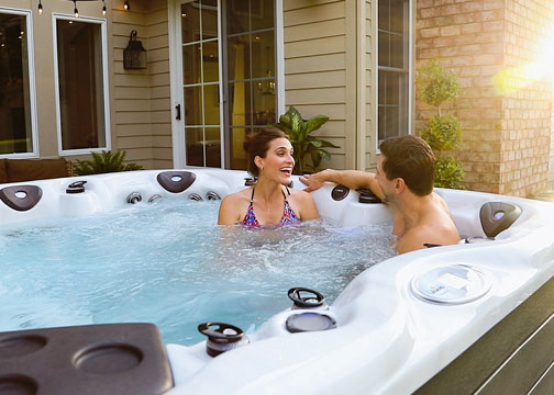 a mother and children having family fun in a hot tub